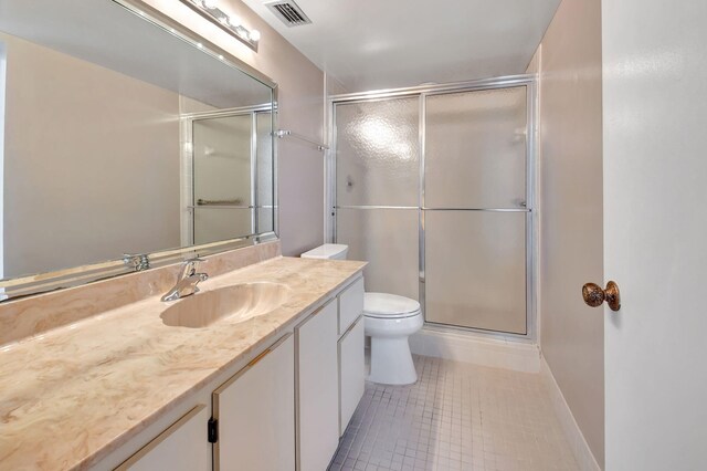 7300 Amberly Ln Unit 101, Delray Beach, FL 33446 - bathroom featuring visible vents, toilet, a shower with door, tile patterned flooring, and vanity
