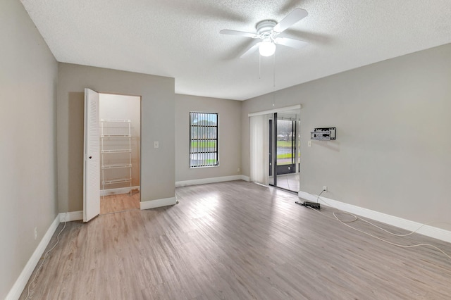 7300 Amberly Ln Unit 101, Delray Beach, FL 33446 - spare room featuring baseboards, a textured ceiling, ceiling fan, and light wood finished floors