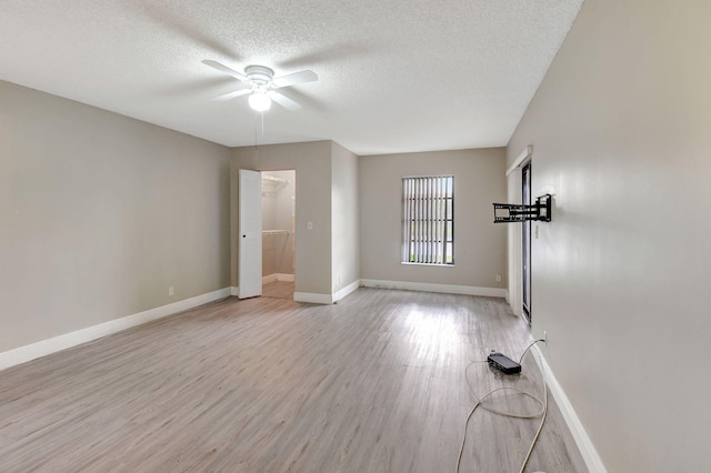 7300 Amberly Ln Unit 101, Delray Beach, FL 33446 - unfurnished room with light wood-style flooring, a textured ceiling, baseboards, and a ceiling fan