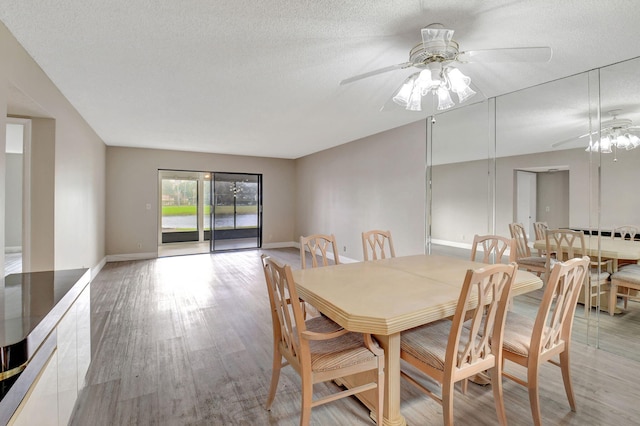 7300 Amberly Ln Unit 101, Delray Beach, FL 33446 - dining space featuring light wood finished floors, a textured ceiling, and a ceiling fan