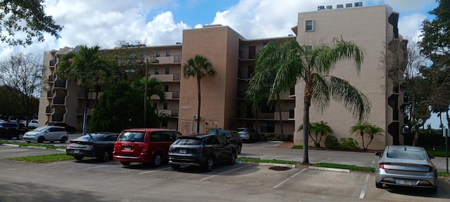 3450 Blue Lake Dr Unit 204, Pompano Beach, FL 33064 - view of property featuring uncovered parking