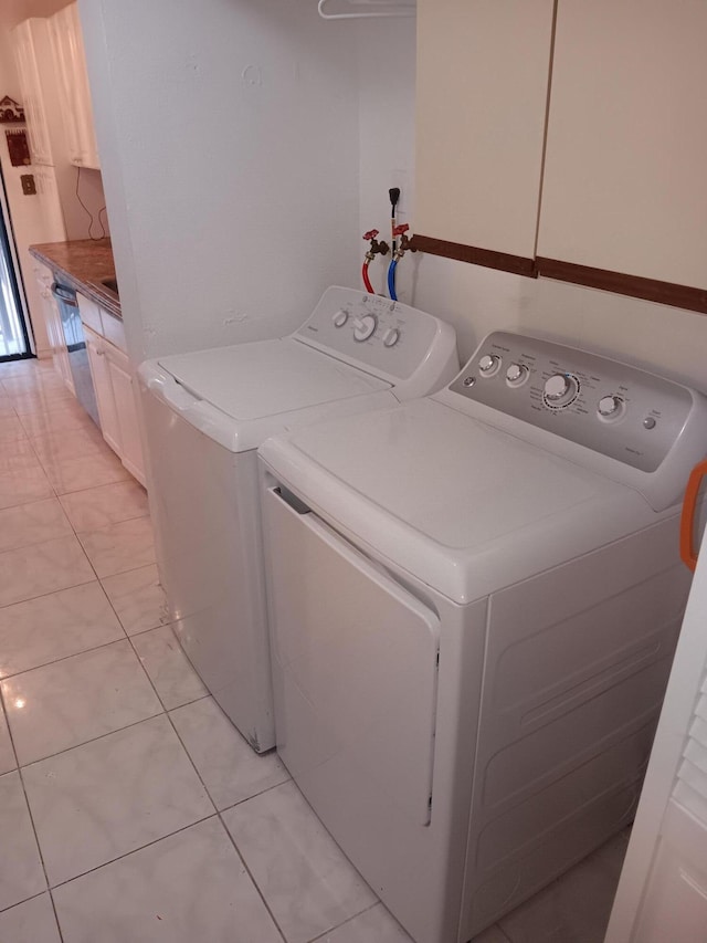 3450 Blue Lake Dr Unit 204, Pompano Beach, FL 33064 - laundry room with light tile patterned floors, independent washer and dryer, and cabinet space