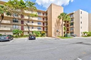 3450 Blue Lake Dr Unit 204, Pompano Beach, FL 33064 - view of building exterior featuring uncovered parking