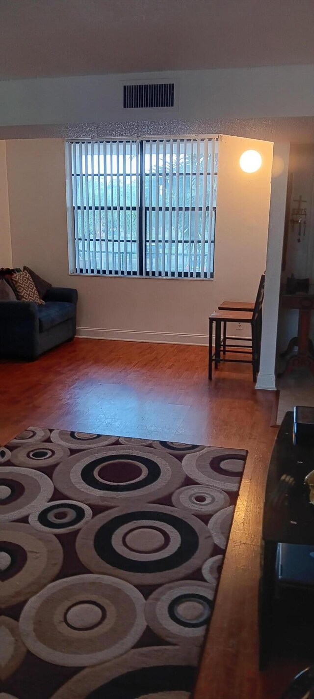 3450 Blue Lake Dr Unit 204, Pompano Beach, FL 33064 - living area with visible vents and wood finished floors