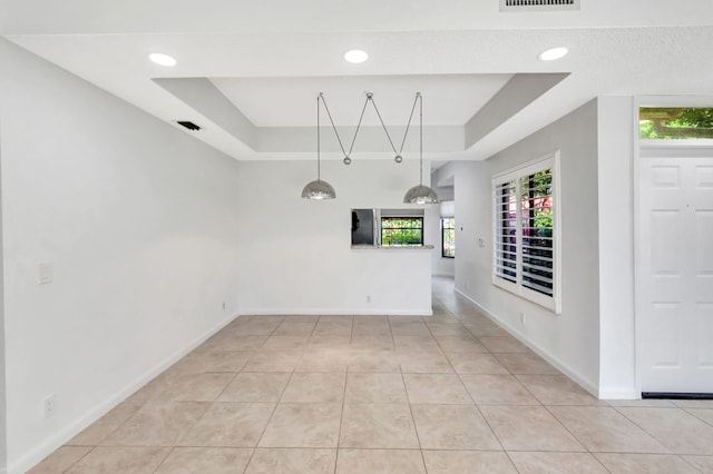 7857 Lexington Club Blvd Unit A, Delray Beach, FL 33446 - unfurnished dining area with tile patterned flooring, a raised ceiling, and baseboards
