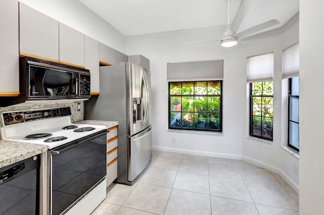 7857 Lexington Club Blvd Unit A, Delray Beach, FL 33446 - kitchen featuring ceiling fan, light countertops, baseboards, light tile patterned floors, and black appliances