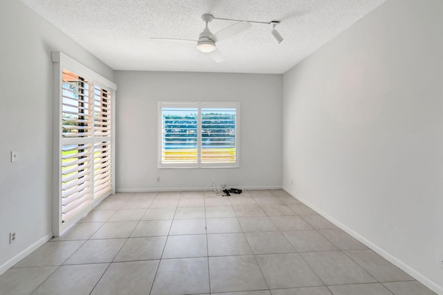 7857 Lexington Club Blvd Unit A, Delray Beach, FL 33446 - spare room with baseboards, a ceiling fan, a textured ceiling, and light tile patterned floors