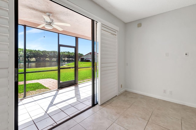 7857 Lexington Club Blvd Unit A, Delray Beach, FL 33446 - doorway to outside with baseboards, a water view, a ceiling fan, and light tile patterned flooring