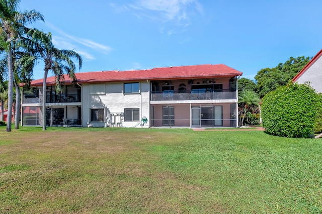 7857 Lexington Club Blvd Unit A, Delray Beach, FL 33446 - rear view of house featuring a yard, stucco siding, and a balcony