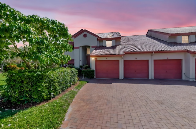 7857 Lexington Club Blvd Unit A, Delray Beach, FL 33446 - mediterranean / spanish home featuring stucco siding, an attached garage, decorative driveway, and a tile roof
