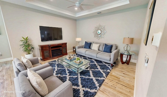 9525 SW Royal Poinciana Dr, Port Saint Lucie, FL 34987 - living room with a tray ceiling, wood finished floors, crown molding, baseboards, and ceiling fan