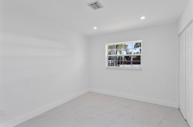 6887 Osborne Dr, Lake Worth, FL 33462 - unfurnished bedroom featuring light marble finish floors, baseboards, recessed lighting, and a closet