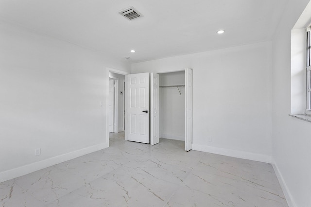6887 Osborne Dr, Lake Worth, FL 33462 - unfurnished bedroom with light marble finish floors, baseboards, recessed lighting, and a closet