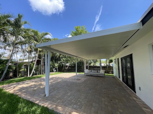 6887 Osborne Dr, Lake Worth, FL 33462 - fenced backyard with an outdoor hangout area and a patio