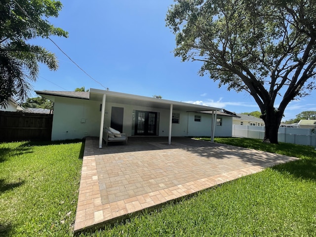 6887 Osborne Dr, Lake Worth, FL 33462 - rear view of property featuring stucco siding, french doors, and a patio area