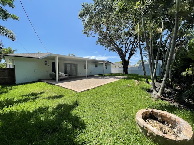 6887 Osborne Dr, Lake Worth, FL 33462 - rear view of property featuring french doors, a patio, and a fire pit