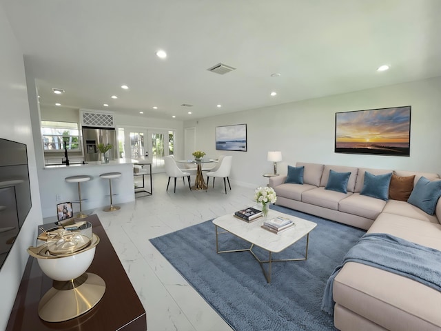 6887 Osborne Dr, Lake Worth, FL 33462 - living area with recessed lighting, marble look tile flooring, and french doors