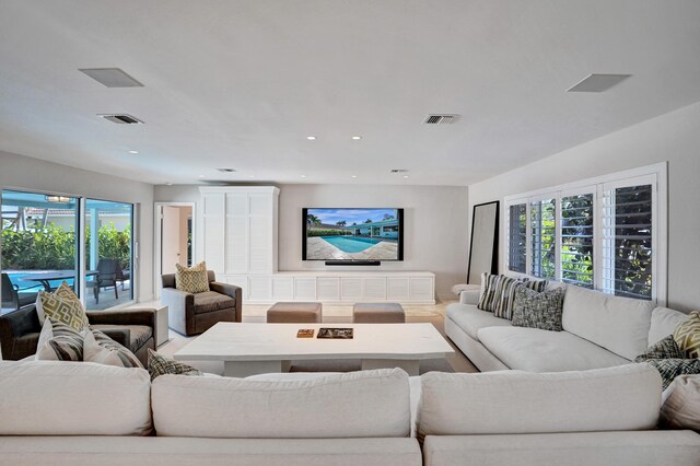living room featuring recessed lighting and visible vents