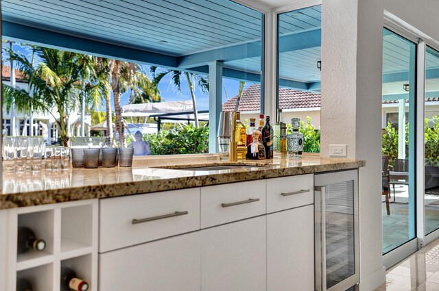 interior space featuring a sink, outdoor dry bar, and beverage cooler