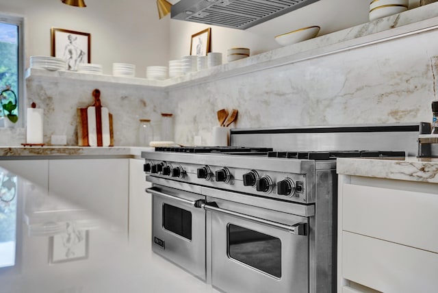 kitchen featuring white cabinetry, light countertops, and double oven range