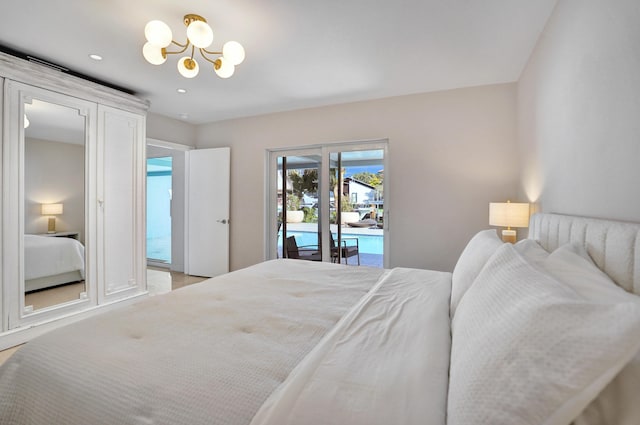 bedroom featuring access to exterior and a chandelier