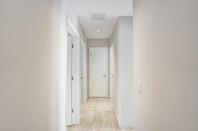 corridor with baseboards and visible vents