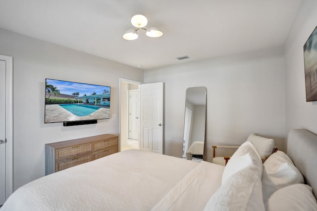 bedroom featuring visible vents and radiator