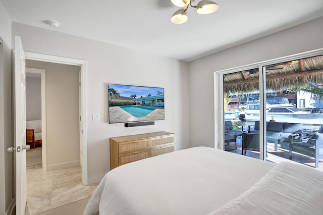 bedroom with baseboards and access to outside