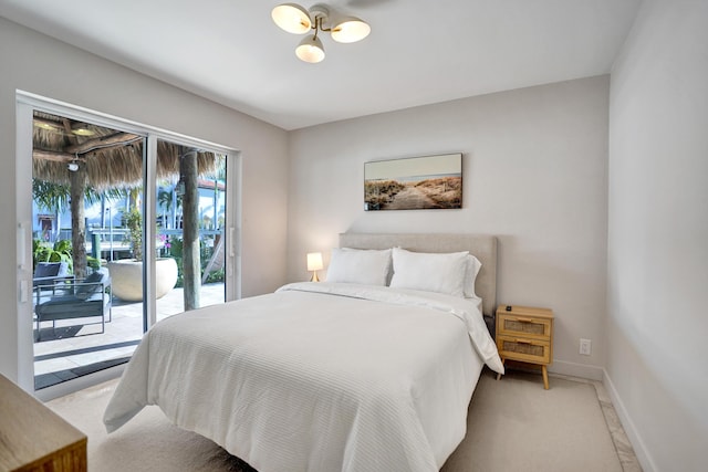 bedroom featuring baseboards and access to outside