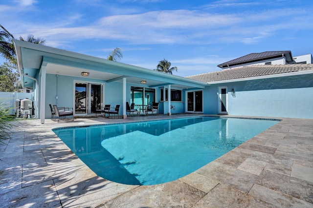 view of swimming pool with a patio and a fenced in pool