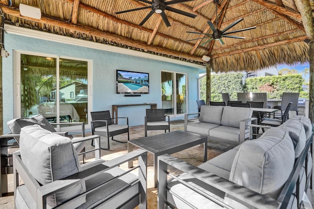 view of patio featuring an outdoor living space, a gazebo, and a ceiling fan