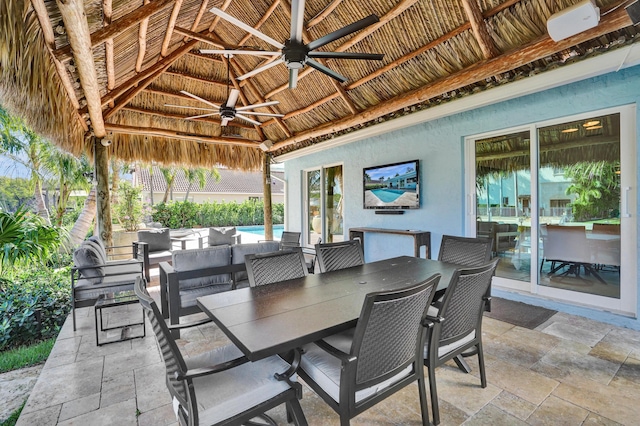 view of patio / terrace with outdoor lounge area, a gazebo, outdoor dining area, and a ceiling fan