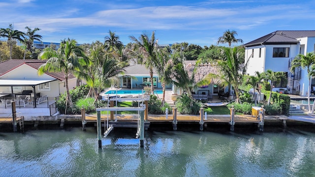 view of dock with fence, a water view, a patio area, and an outdoor pool