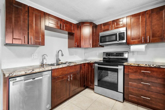 kitchen with light stone counters, light tile patterned floors, a sink, stainless steel appliances, and a textured ceiling