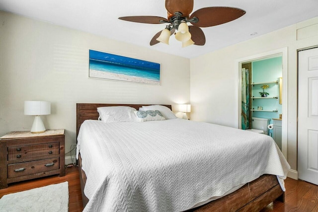 bedroom with wood finished floors, baseboards, and connected bathroom