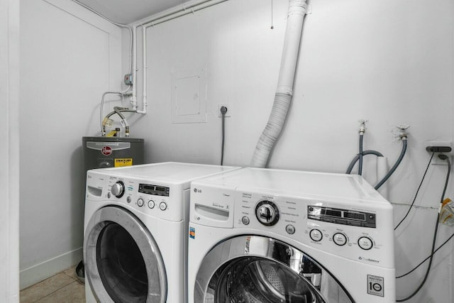 washroom featuring laundry area, light tile patterned floors, washing machine and dryer, and baseboards