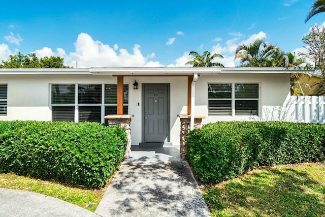 doorway to property featuring stucco siding