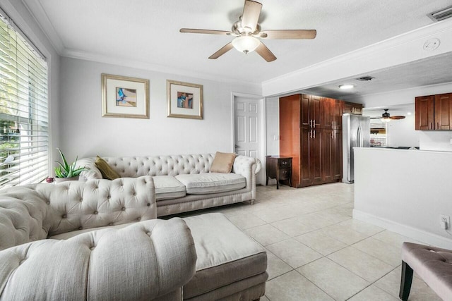 living room with ornamental molding, visible vents, light tile patterned floors, and ceiling fan