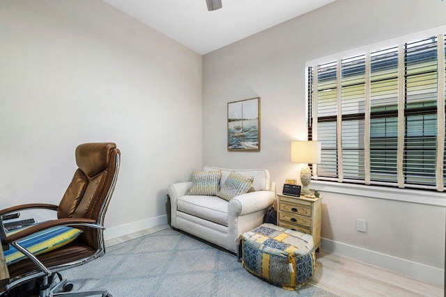 office space featuring a ceiling fan, wood finished floors, and baseboards