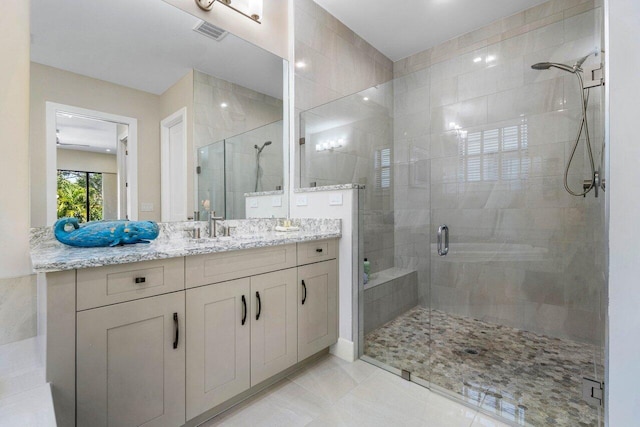 bathroom with vanity, a shower stall, and visible vents