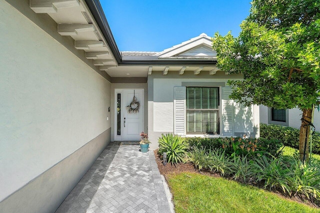 doorway to property with stucco siding