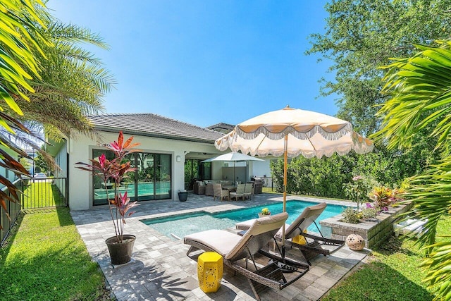 pool with outdoor lounge area, a patio, and fence