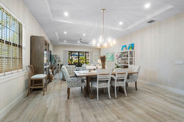 dining area with visible vents, baseboards, a tray ceiling, recessed lighting, and light wood-style floors