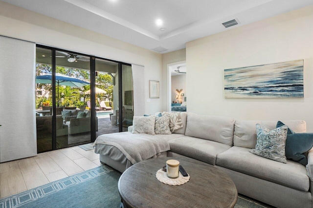 living room with visible vents, french doors, and a tray ceiling