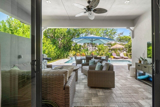 view of patio with an outdoor pool, an outdoor hangout area, and a ceiling fan