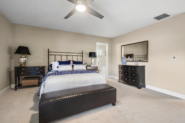 bedroom featuring light colored carpet, visible vents, baseboards, and a ceiling fan