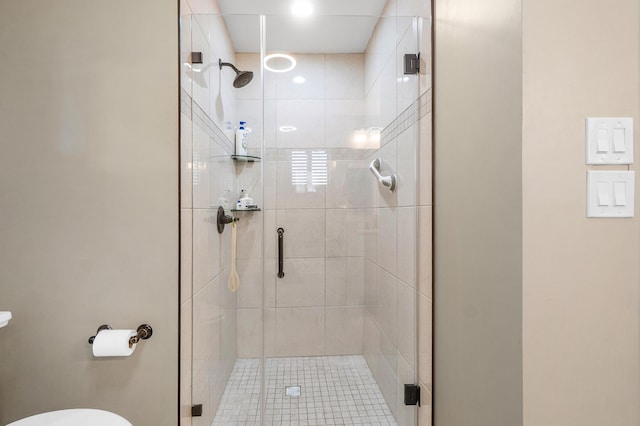 full bath featuring toilet and a shower stall