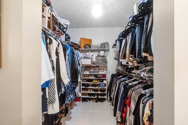 walk in closet with tile patterned flooring