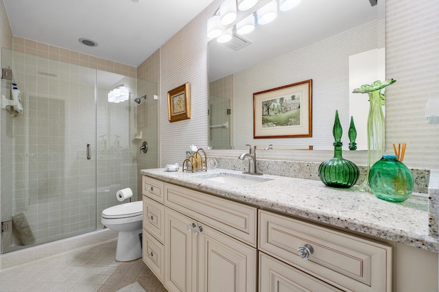 bathroom with a shower stall, tile patterned floors, toilet, and vanity