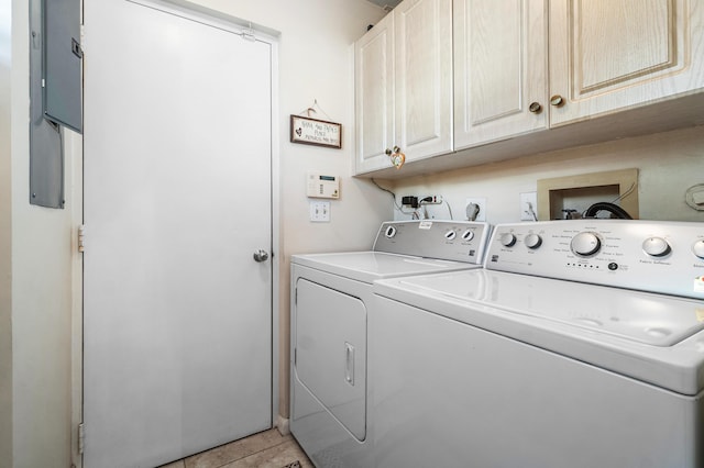 laundry area with independent washer and dryer and cabinet space